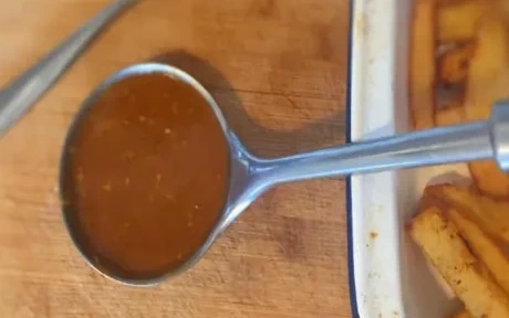 curry sauce in a ladle with chips
