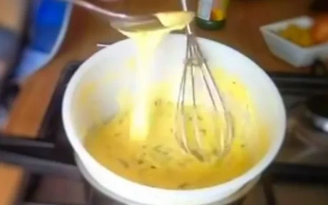 hollandaise sauce being whisked