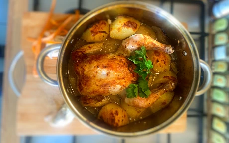chicken in a pot of gravy with a probe